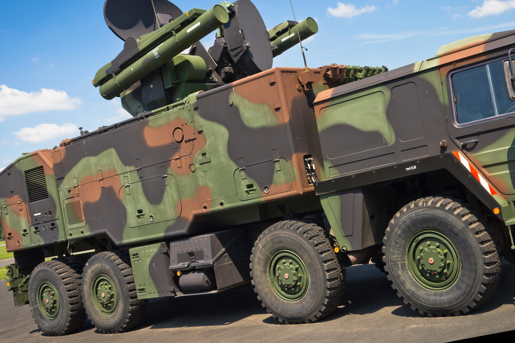 Camouflage military vehicle outside.